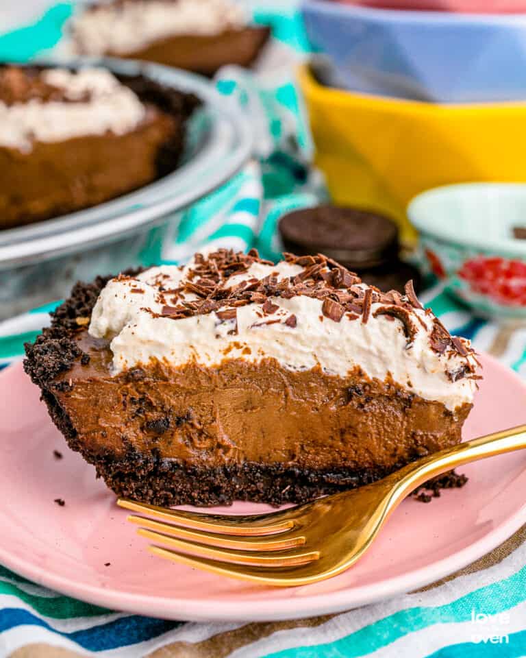 A slice of chocolate cream pie topped with whipped cream.