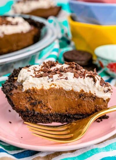 A slice of chocolate cream pie topped with whipped cream.