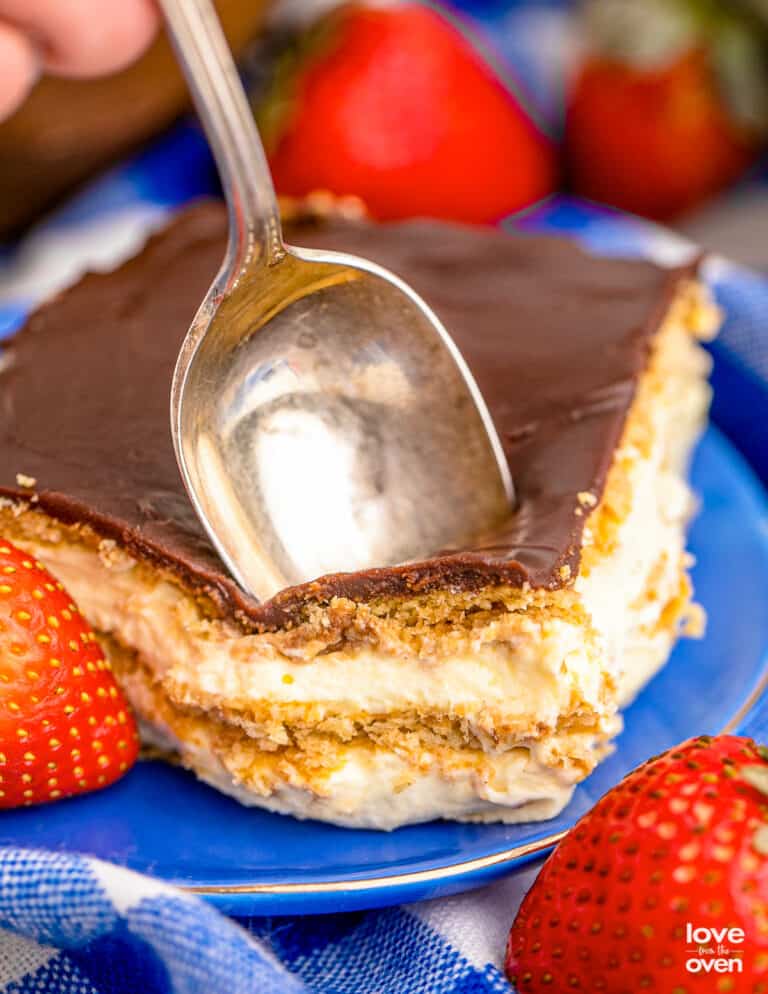 A spoon in a chocolate eclair cake