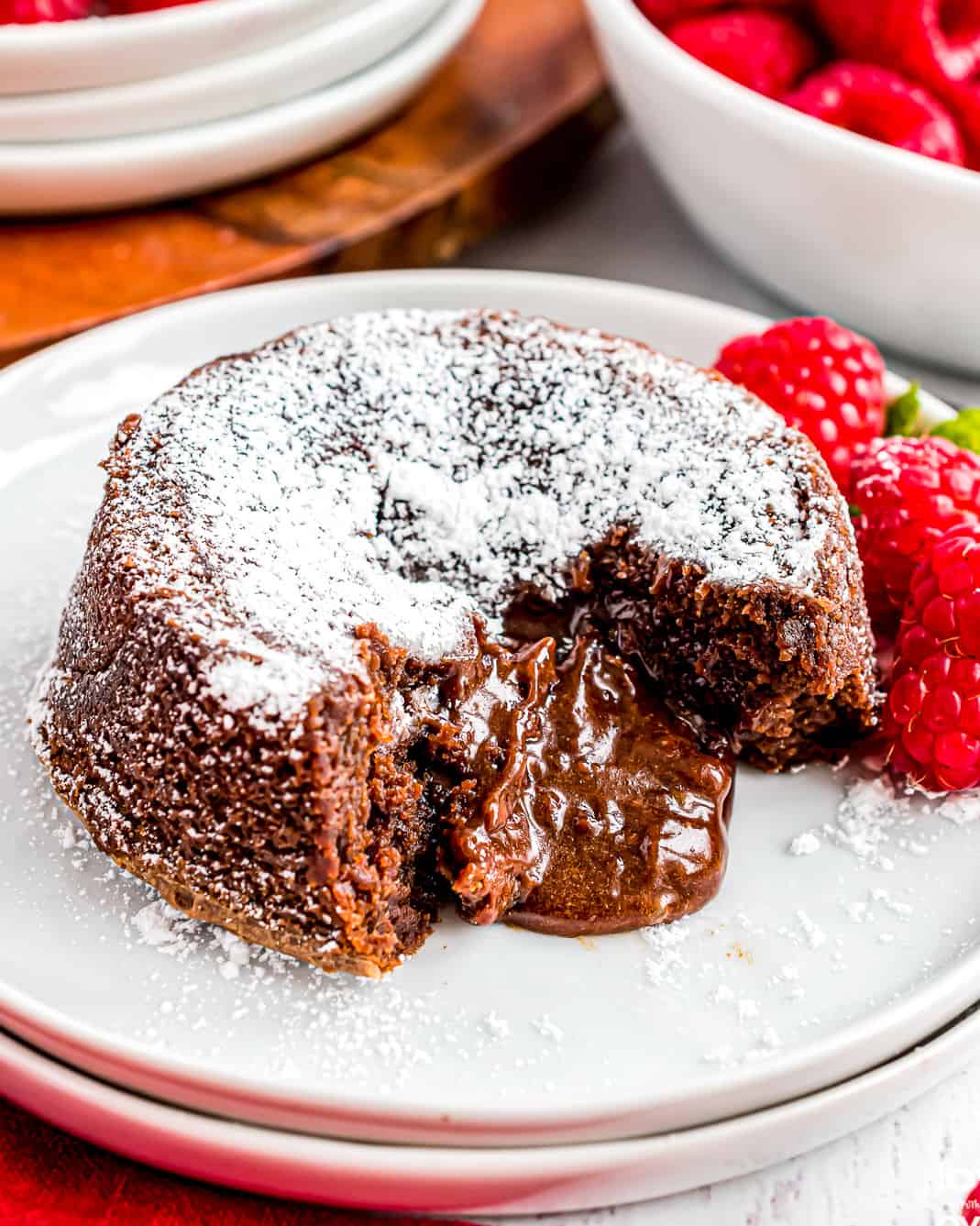 A molten chocolate lava cake with raspberries.