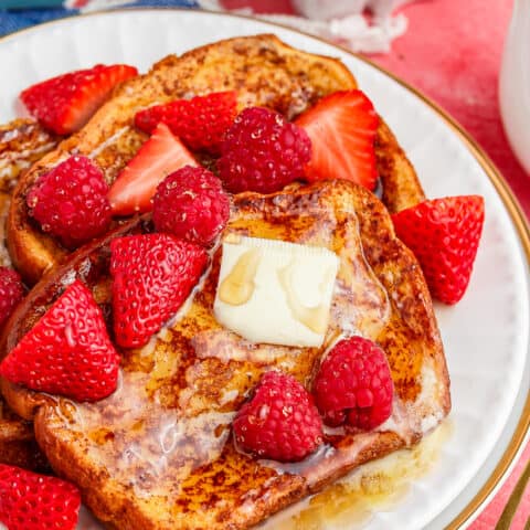 A plate of brioche french toast with berries