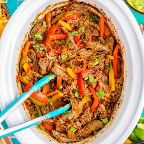 Fajitas in a white crockpot.