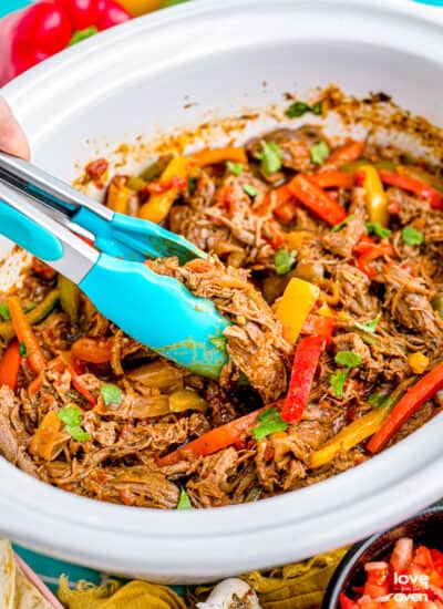 Fajitas in a white crockpot.