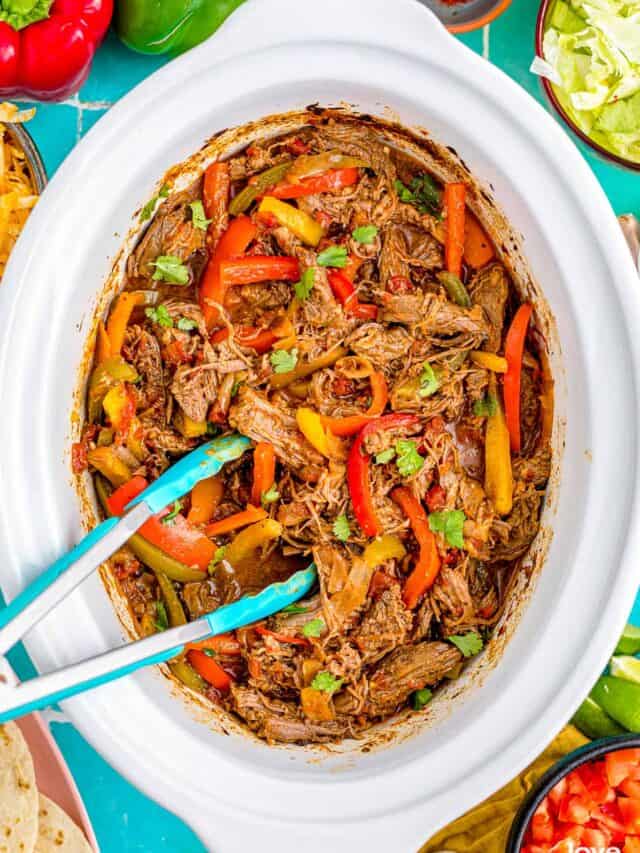 Fajitas in a white crockpot.