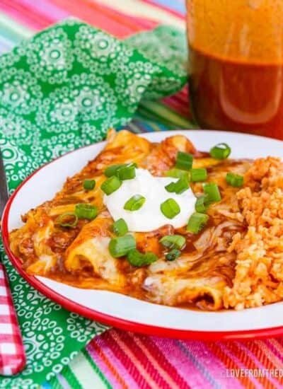 A plate of Cheese Enchiladas served with Mexican Spanish rice
