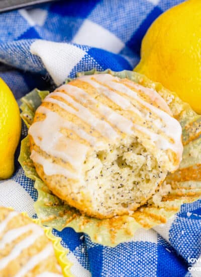 Lemon poppy seed muffins on a blue and white napkin.