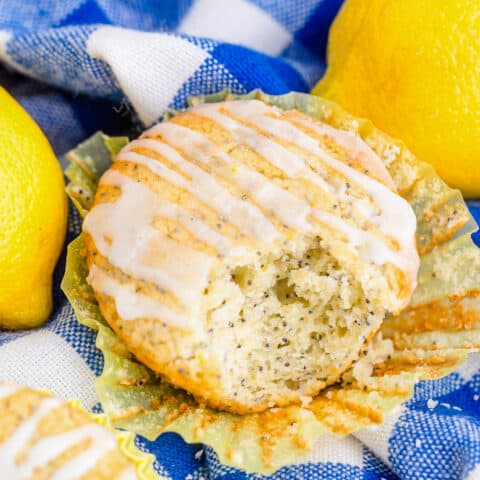 Lemon poppy seed muffins on a blue and white napkin.