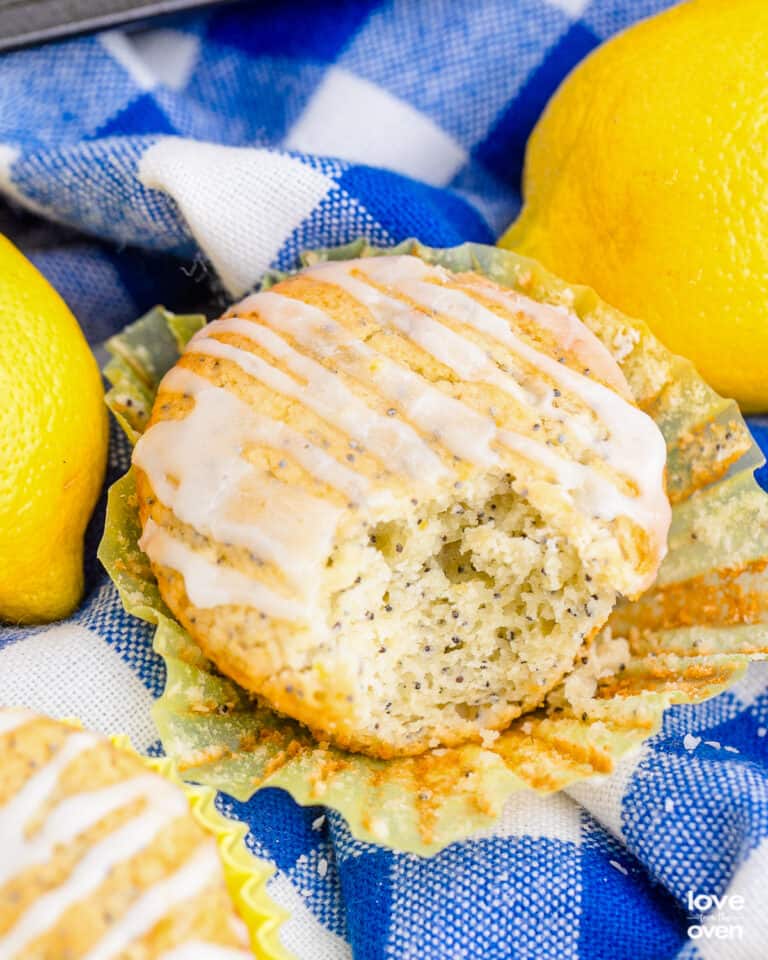 Lemon poppy seed muffins on a blue and white napkin.