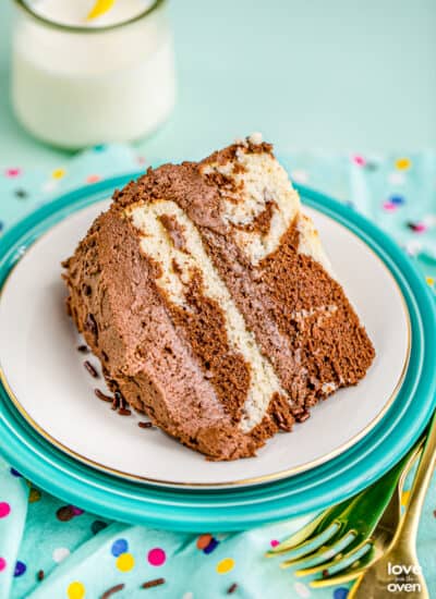 A slice of marble cake on a blue background.