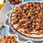 A photo of a peanut butter pie on a blue background