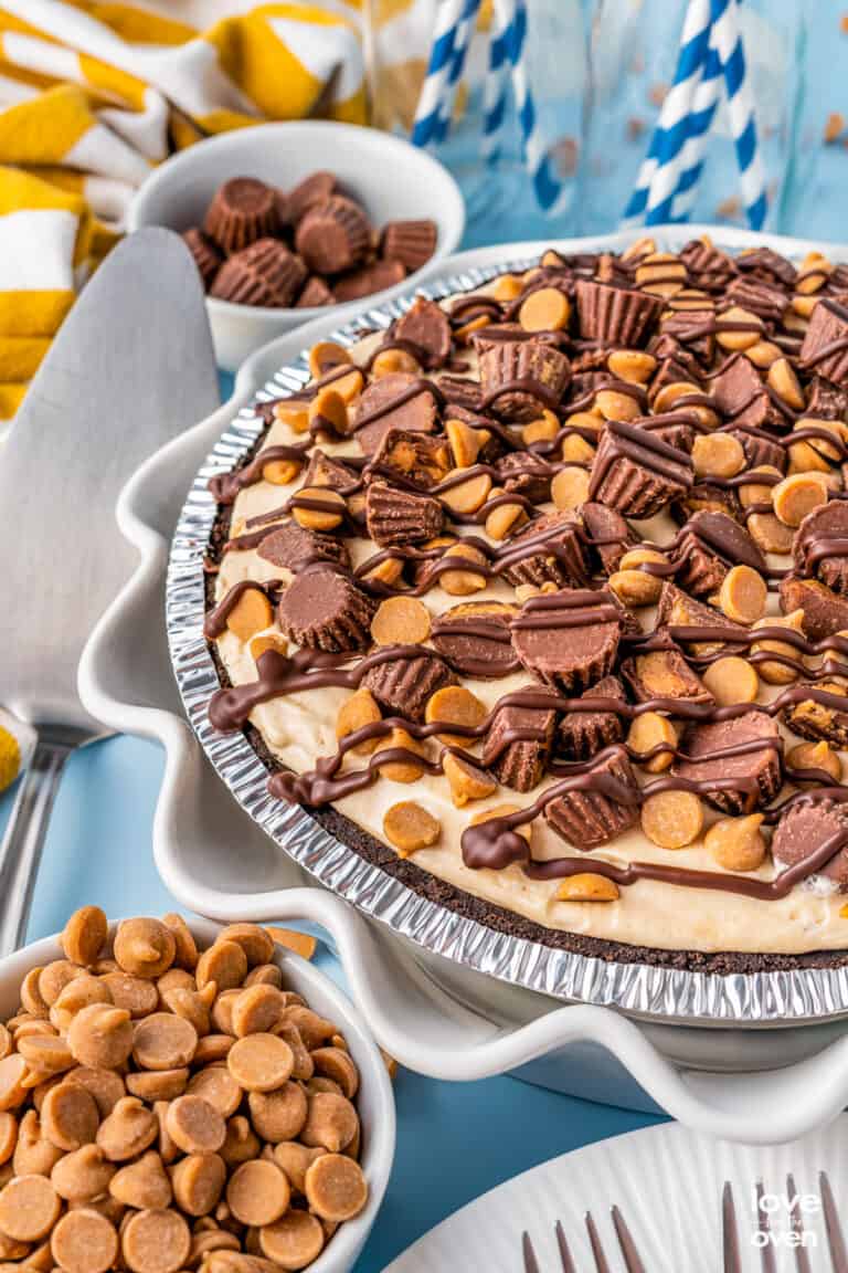 A photo of a peanut butter pie on a blue background