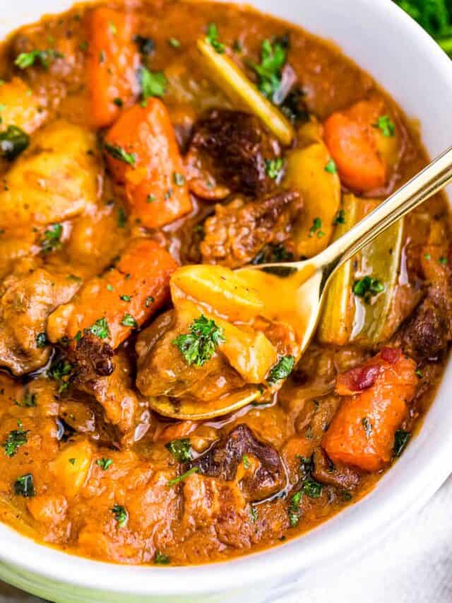 a bowl of guinness beef stew with a spoon in it