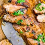 slice of grilled pork tenderloin on a cutting board