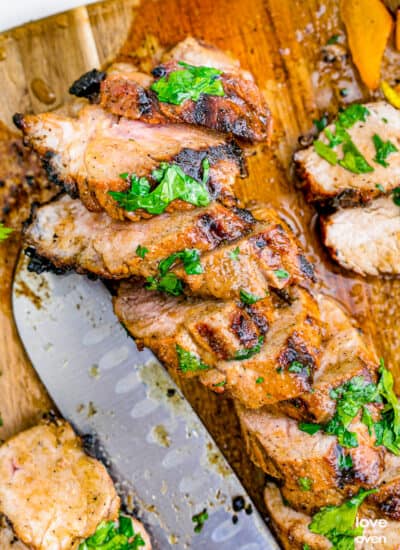 slice of grilled pork tenderloin on a cutting board
