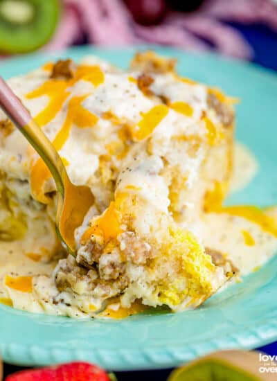 a fork digging into biscuits and gravy casserole