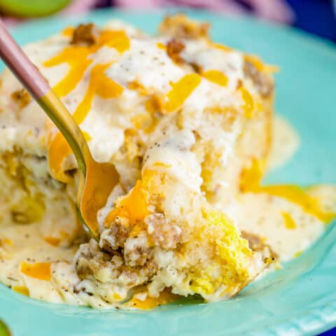 a fork digging into biscuits and gravy casserole