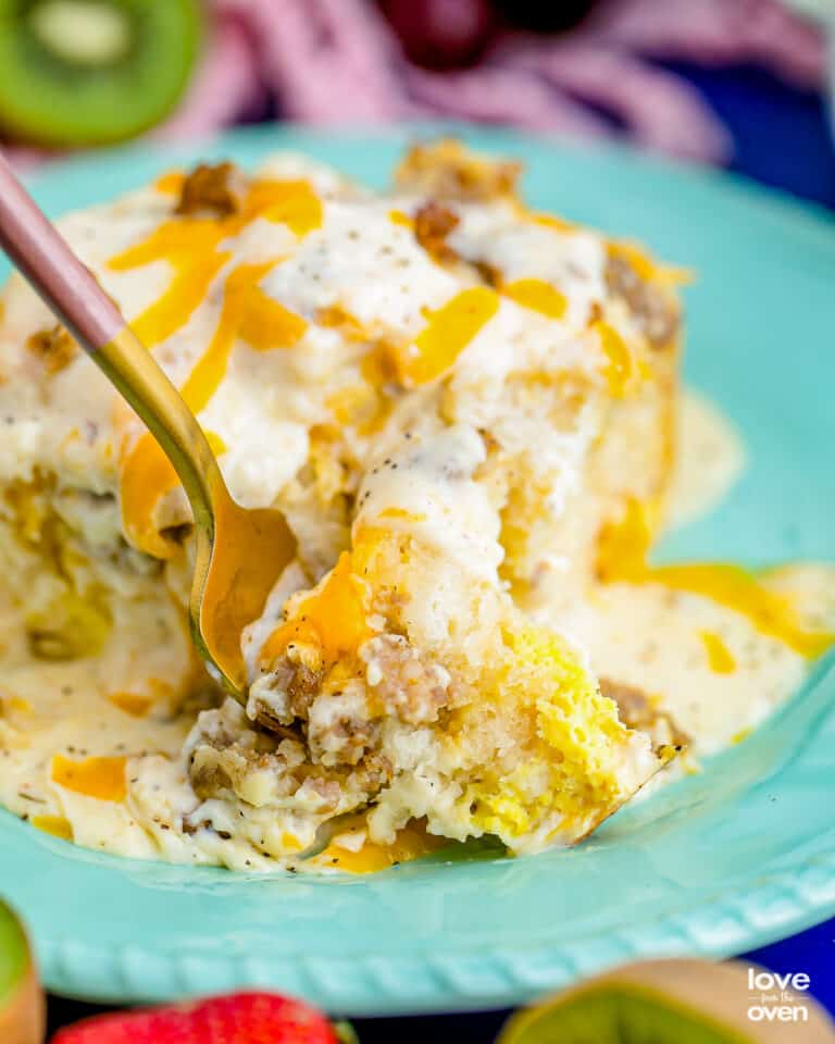 a fork digging into biscuits and gravy casserole