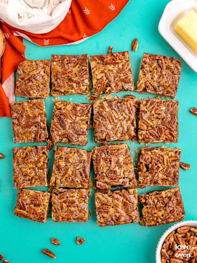 pecan pie bars cut into squares on a blue table