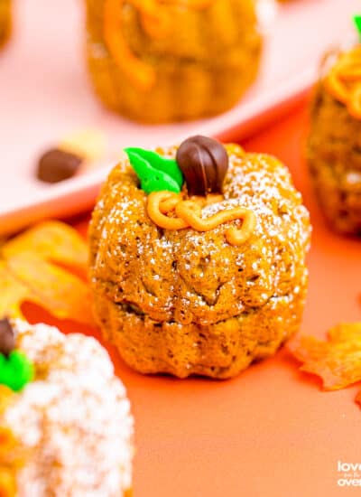 mini pumpkin bundt cakes on an orange background.