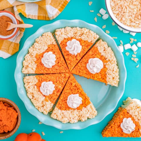 A pie pan full of pumpkin pie rice krispie treats on a blue background.