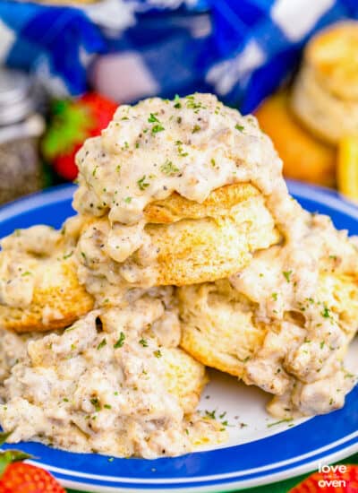 A stack of biscuits and gravy on a blue and white plate.