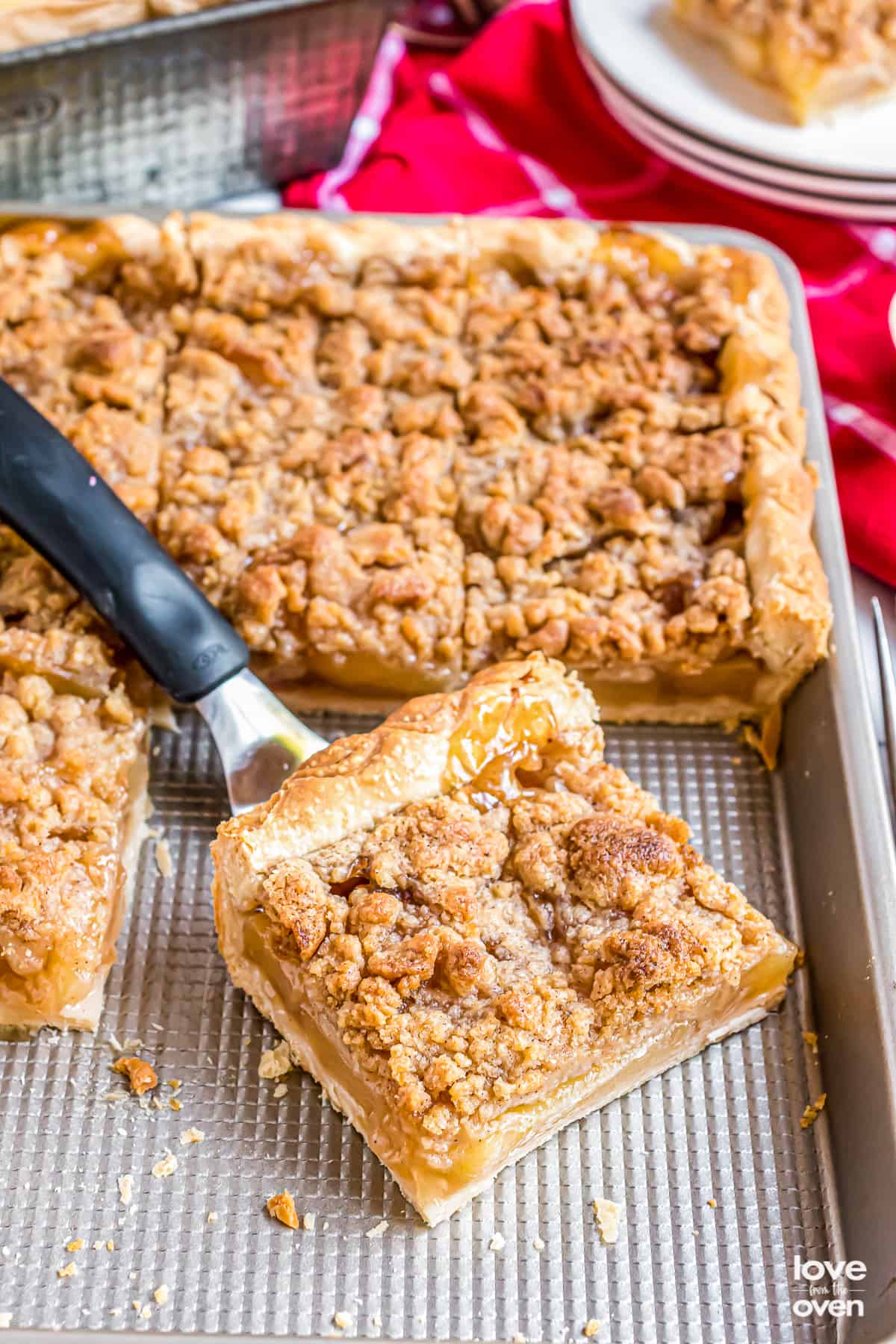 a slice of apple pie in a baking pan