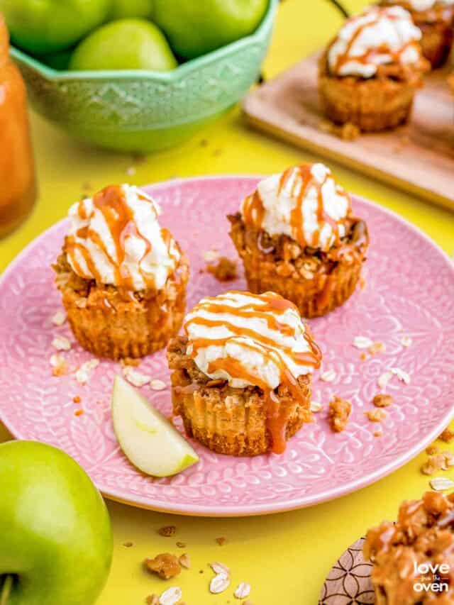 mini caramel apple cheesecakes on a pink plate