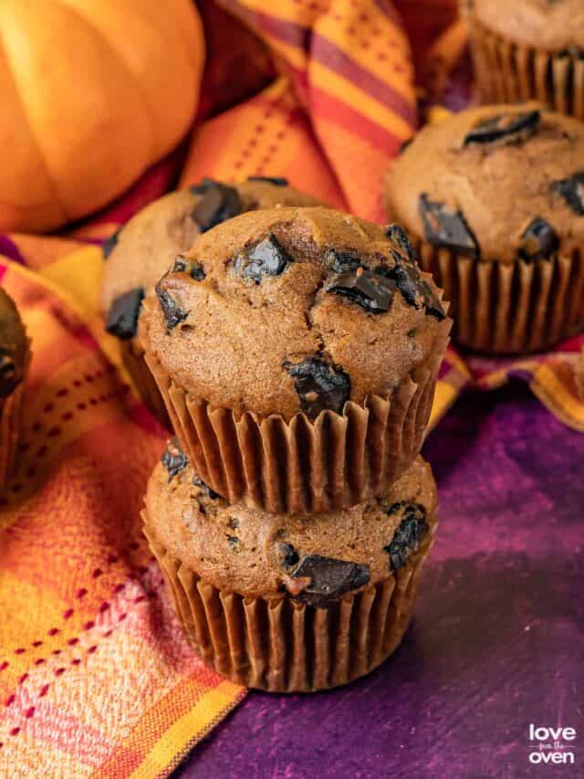 pumpkin chocolate chip muffins stacked on top of each other