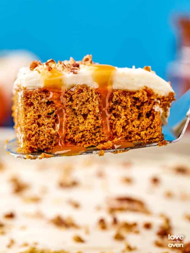A pumpkin poke cake with caramel dripping down it, on a serving spatula.