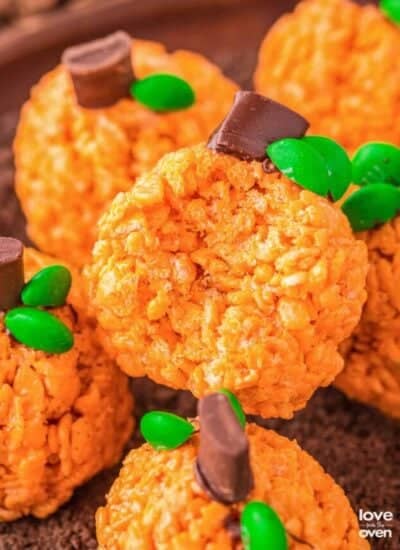 A plate of rice krispies treats that look like pumpkins.