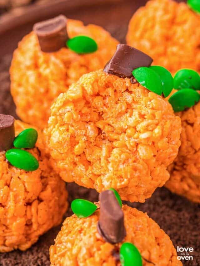 A plate of rice krispies treats that look like pumpkins.