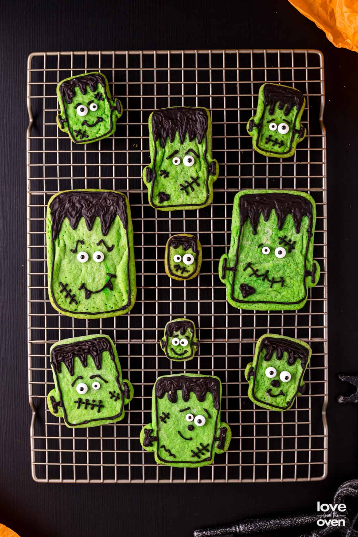 halloween sugar cookies on a metal cooling rack.