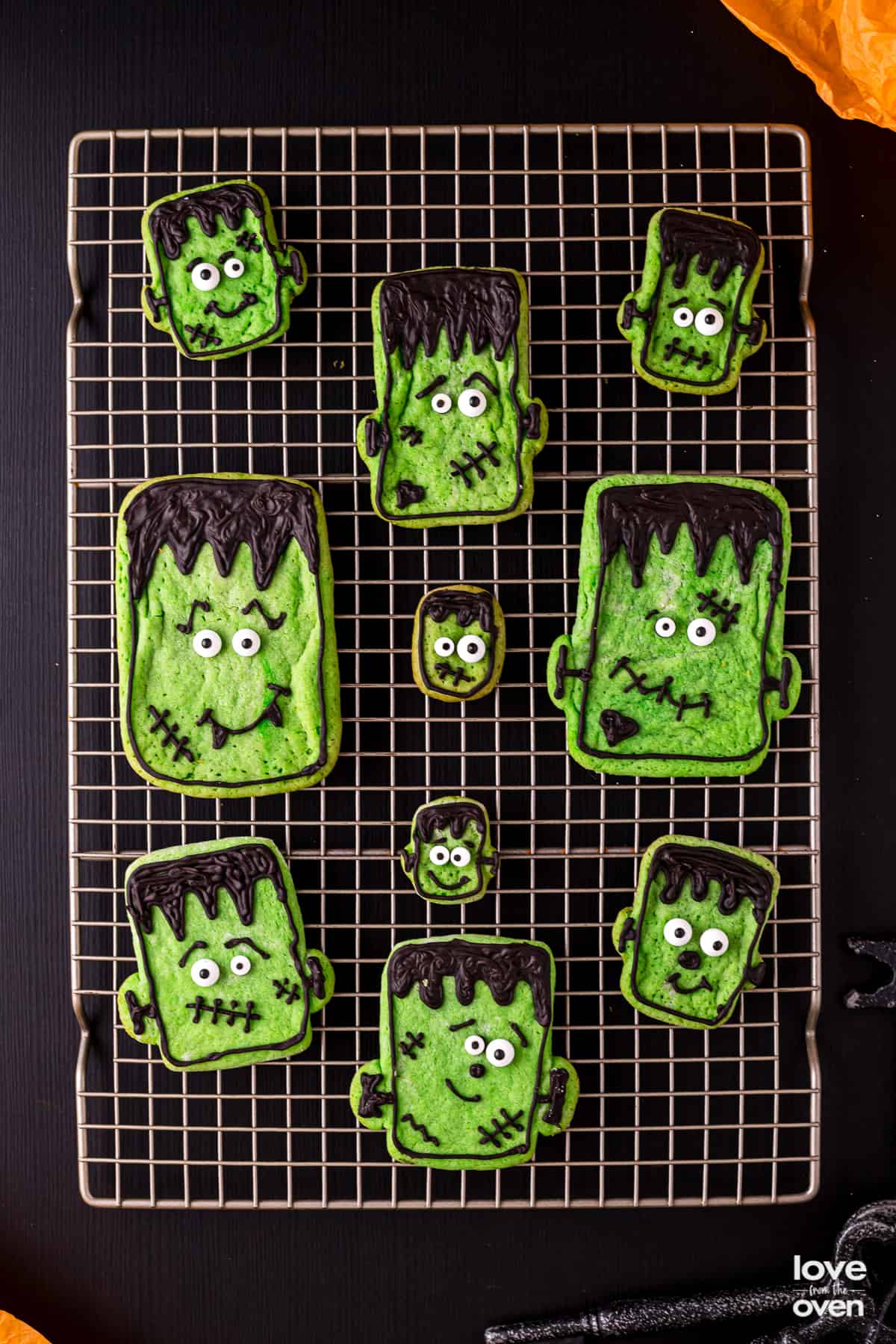 halloween sugar cookies on a metal cooling rack.