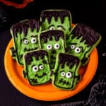 A plate of halloween cookies that look like Frankenstein.