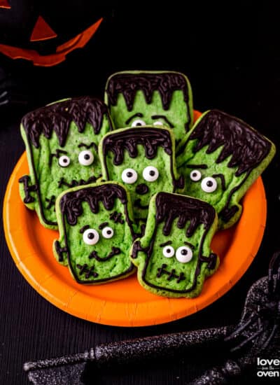 A plate of halloween cookies that look like Frankenstein.