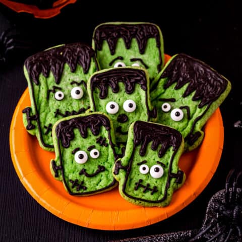 A plate of halloween cookies that look like Frankenstein.