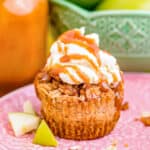 A mini caramel apple cheesecake on a pink plate.