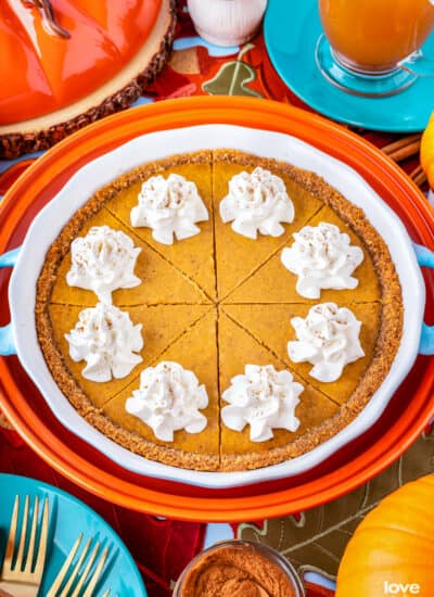 A sliced pumpkin pie with graham cracker crust.