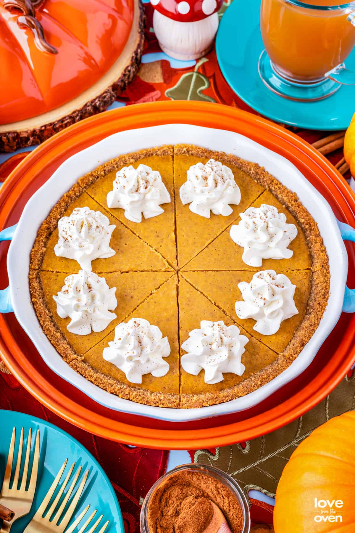 A sliced pumpkin pie with graham cracker crust.