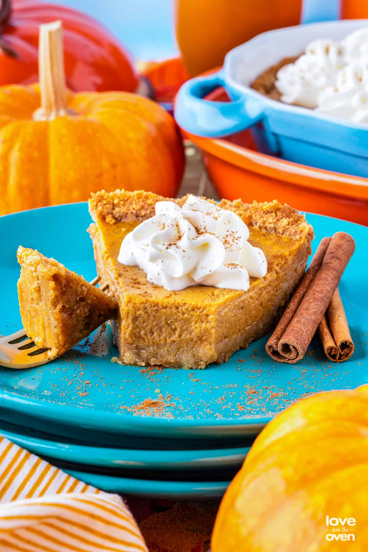 A slice of pumpkin pie on a blue plate.