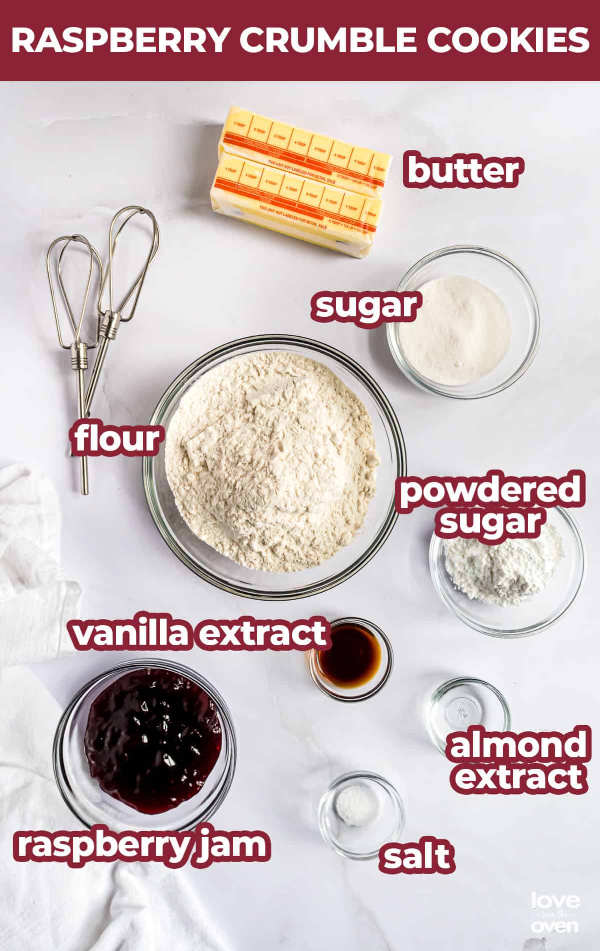 Ingredients for raspberry crumble cookies on a white surface.