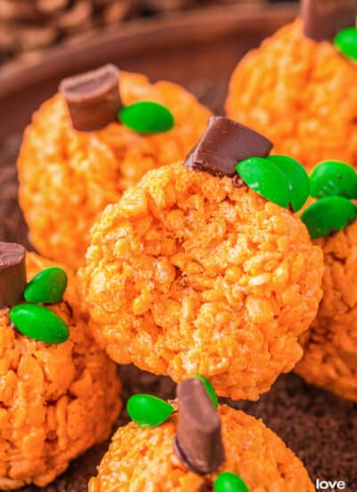 A plate of rice krispies treats that look like pumpkins.