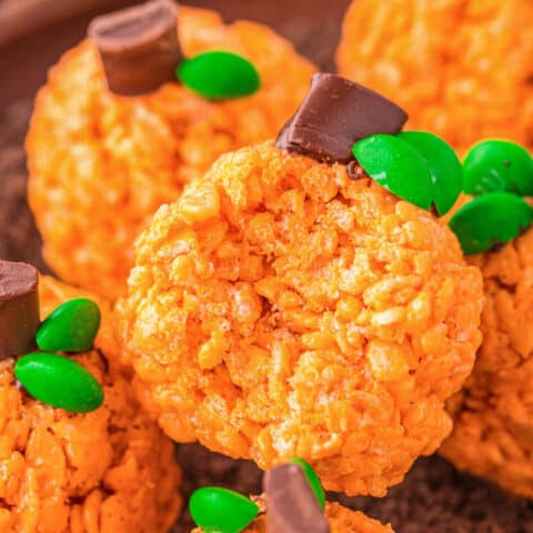 A plate of rice krispies treats that look like pumpkins.