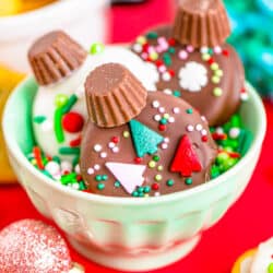 Chocolate covered ritz crackers decorated to look like ornaments, in a bowl.