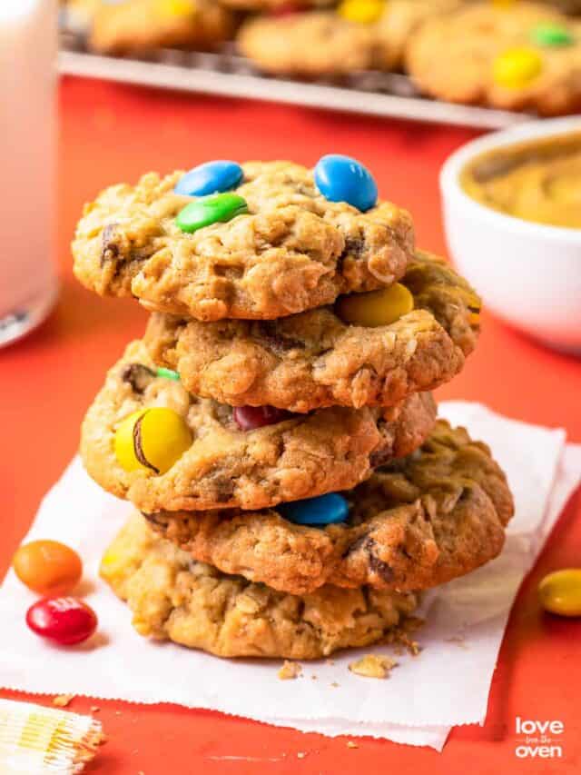 A stack of monster cookies on a napkin