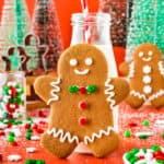 A gingerbread man cookie leaning on a small milk bottle