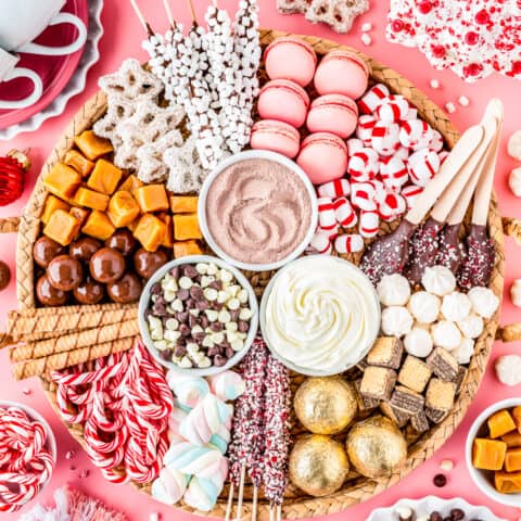 A hot chocolate charcuterie board filled with toppings and candies.