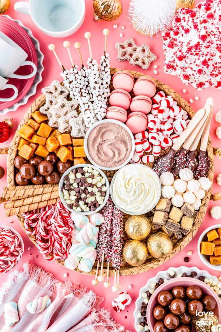 A hot chocolate charcuterie board filled with toppings and candies.