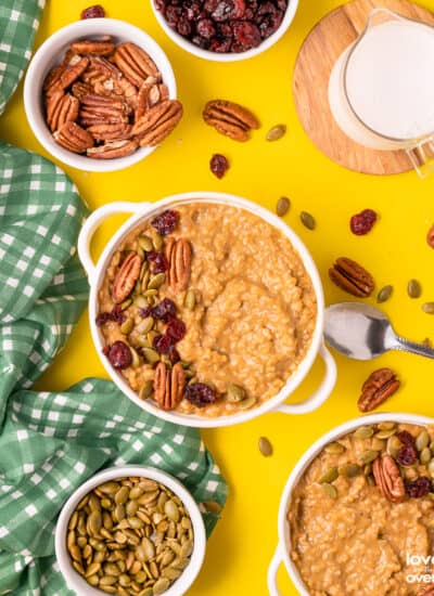 a bowl of pumpkin oatmeal with toppings on a yellow table