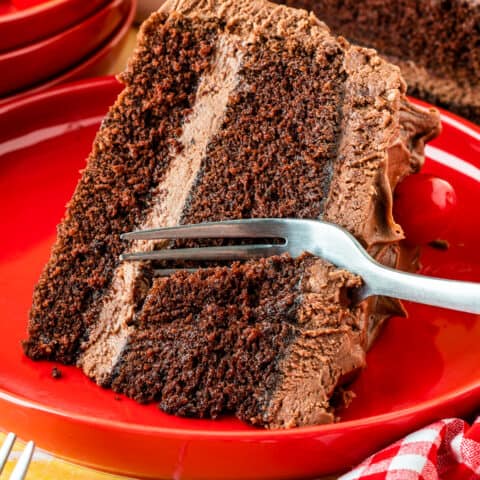 A fork taking a slice out of a mayonnaise cake